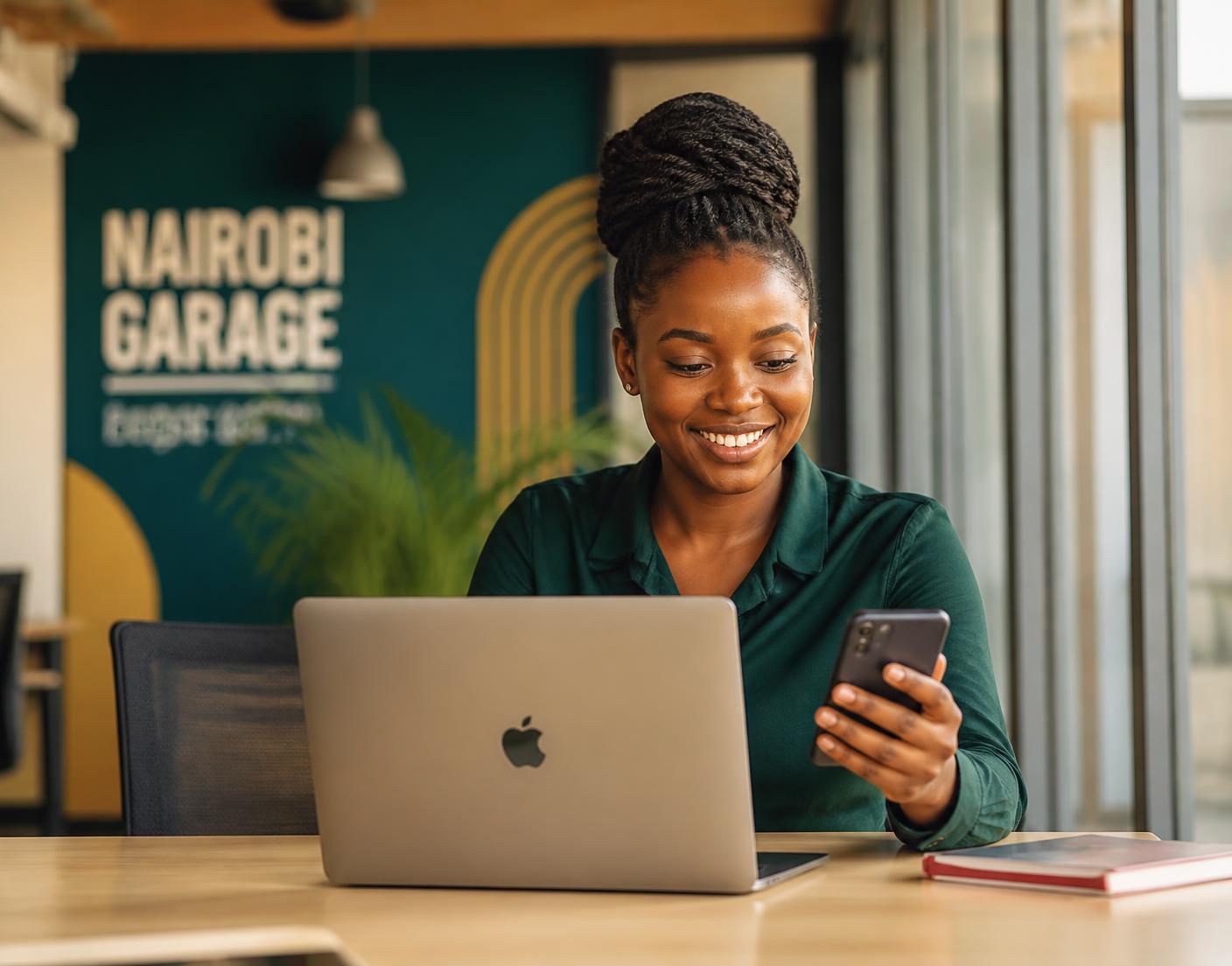 A Kenyan student learning digital skills on a laptop and phone